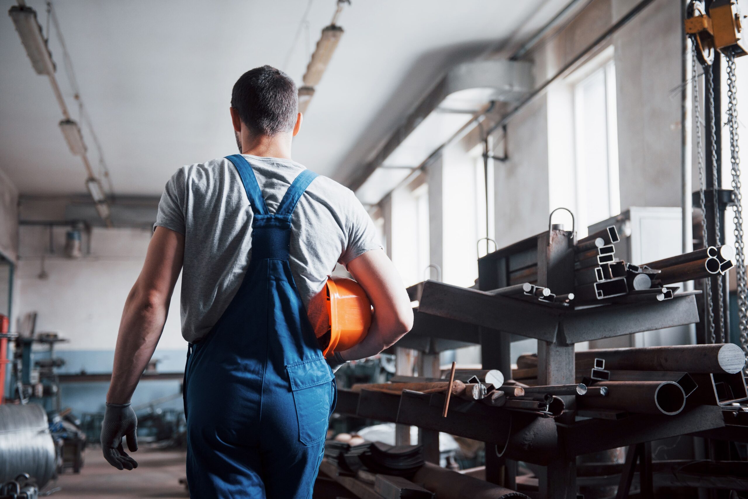 portrait-young-worker-hard-hat-large-waste-recycling-factory-min